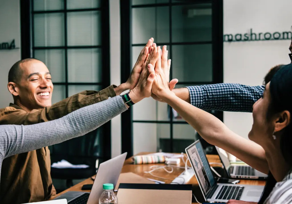 student giving a group high five